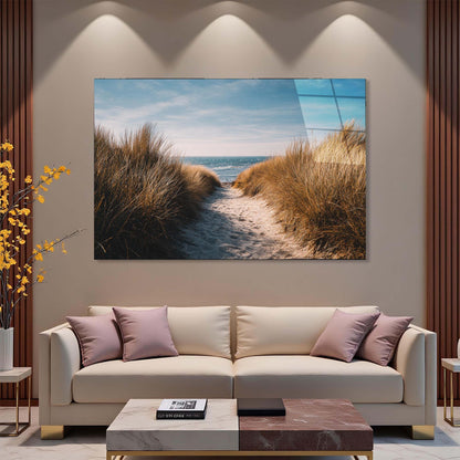 Modern living room with a large TV displaying a beach scene, beige sofa, and decorative elements.