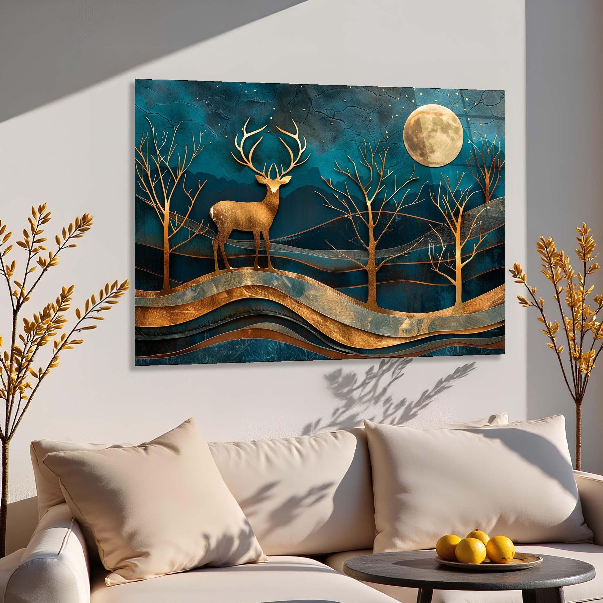Decorative wall art of a deer in a forest with a full moon above, hanging above a sofa.
