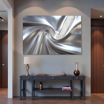 Modern interior with a large abstract metal sculpture on the wall above a dark wooden console table.