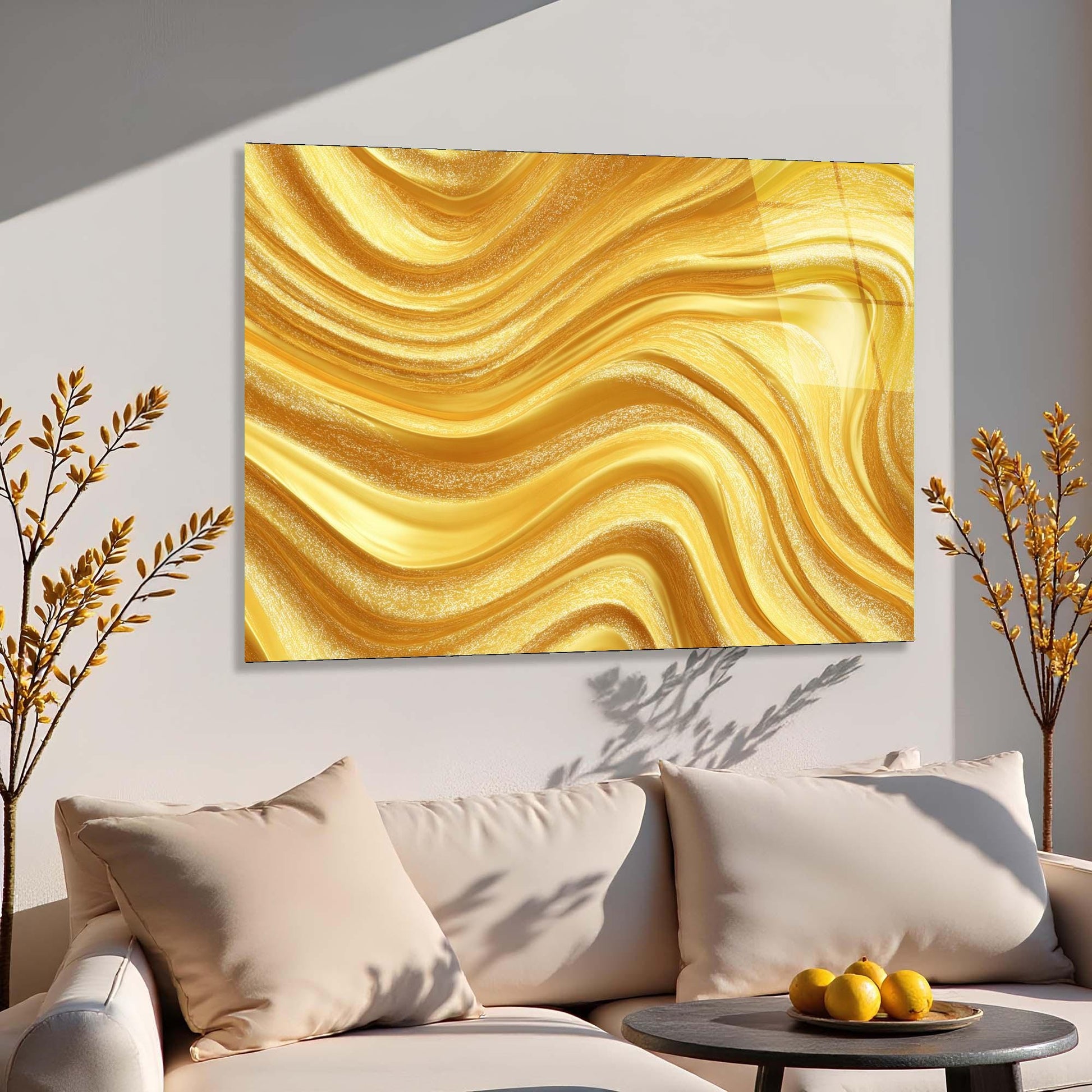 Abstract gold painting on a wall above a beige sofa with decorative elements.