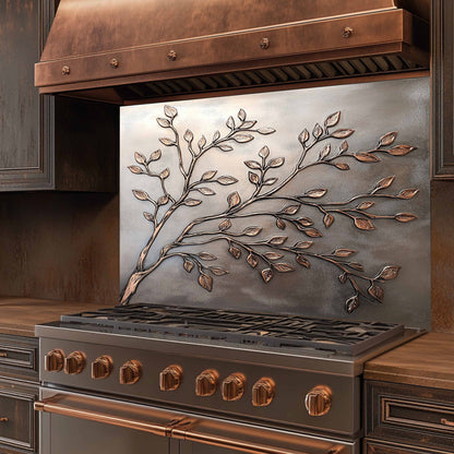 Stainless steel stove with decorative leaf design on the back splash in a kitchen setting.