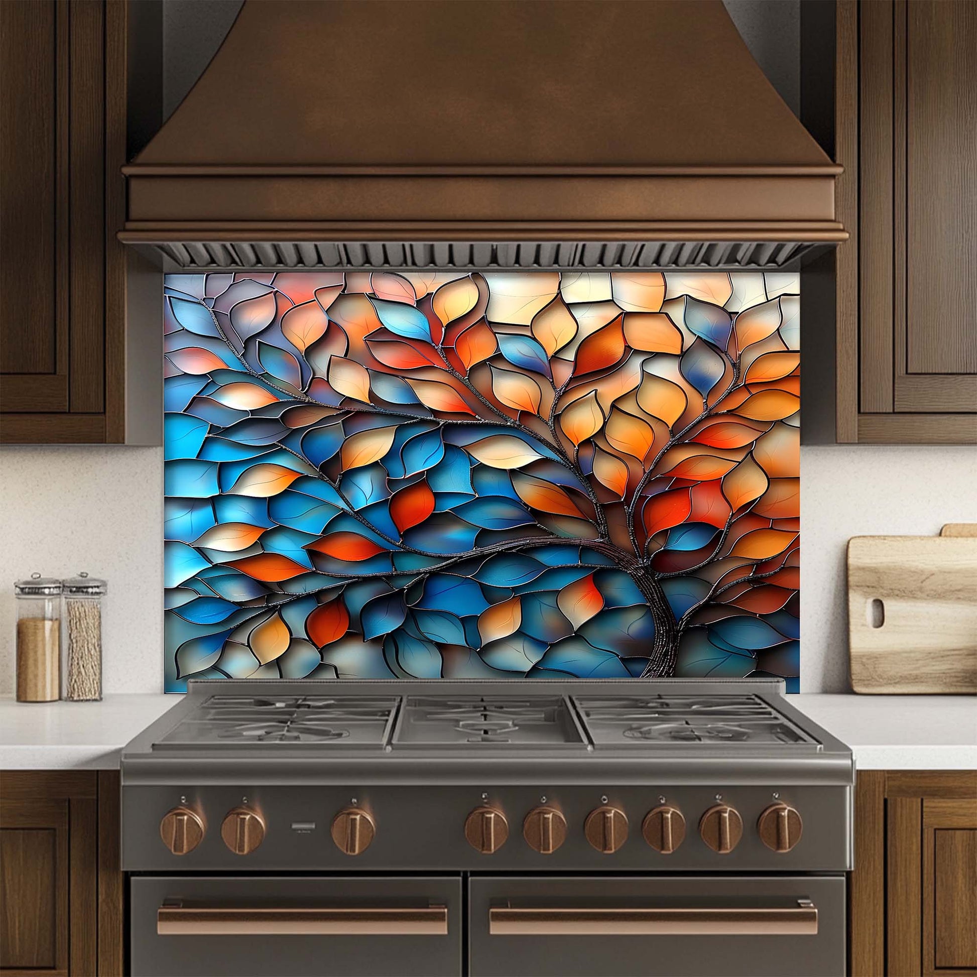 Kitchen stove with a colorful glass splashback featuring leaf patterns.