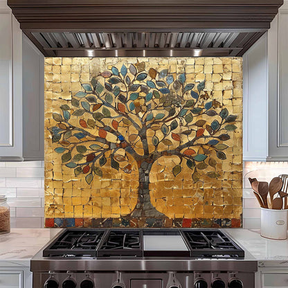 Kitchen stove with decorative mosaic glass backsplash featuring a tree and fruit.