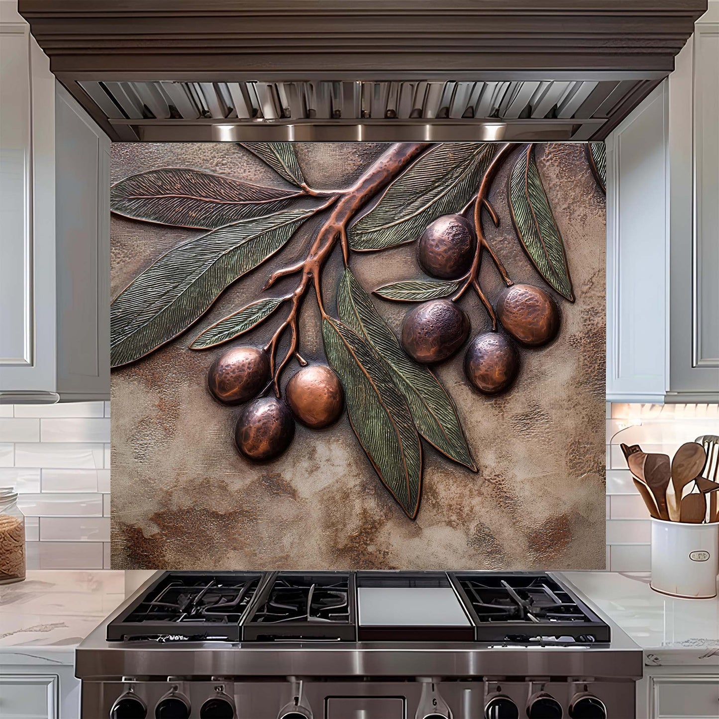 Decorative glass backsplash with olive branch design above a stove in a kitchen.