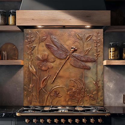 Decorative copper look glass backsplash with floral and dragonfly design above a stove.