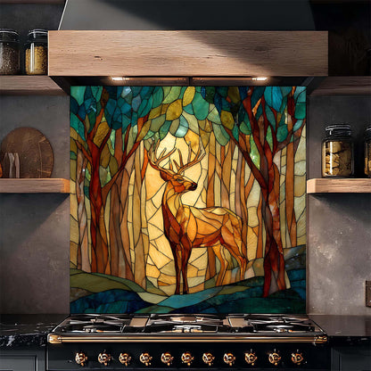 Decorative glass backsplash with a deer in a forest design above a stove in a kitchen.