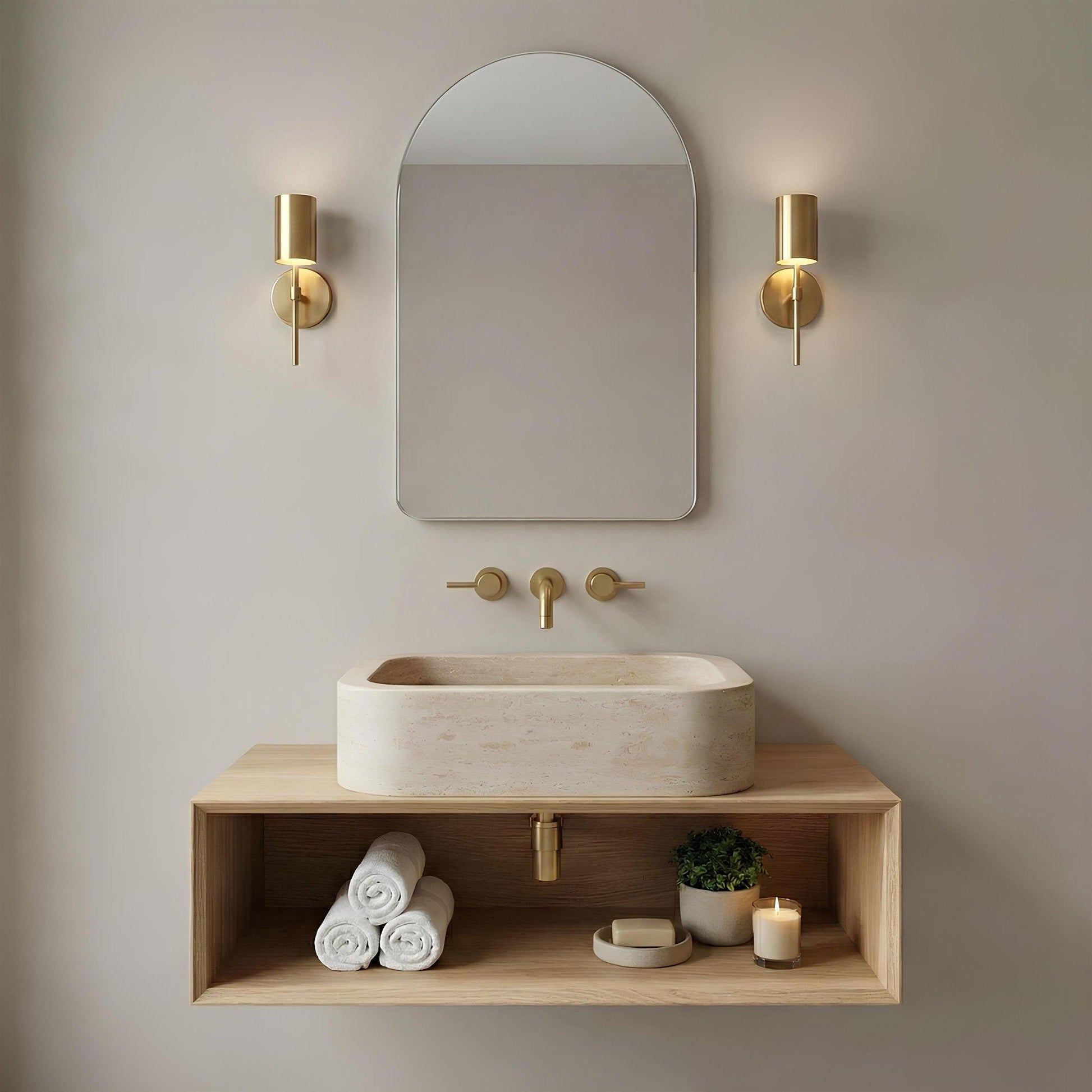 Bathroom vanity with sink, mirror, and decorative elements against a neutral wall.