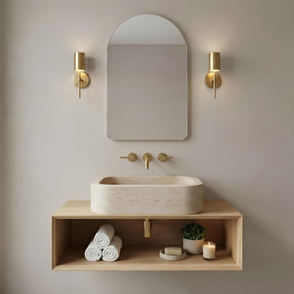 Bathroom vanity with sink, mirror, and decorative elements against a neutral wall.