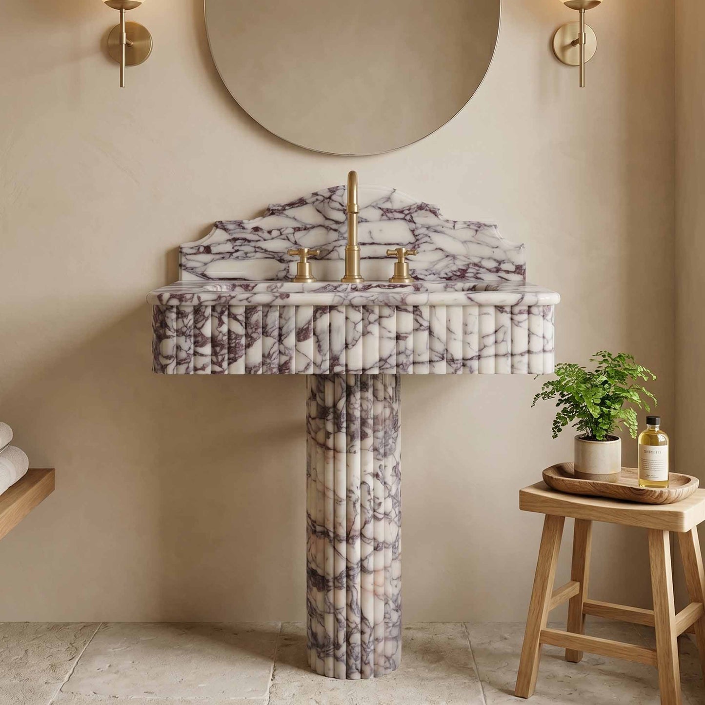 Calacatta viola marble pedestal sink in a bathroom setting with a stool and plant.