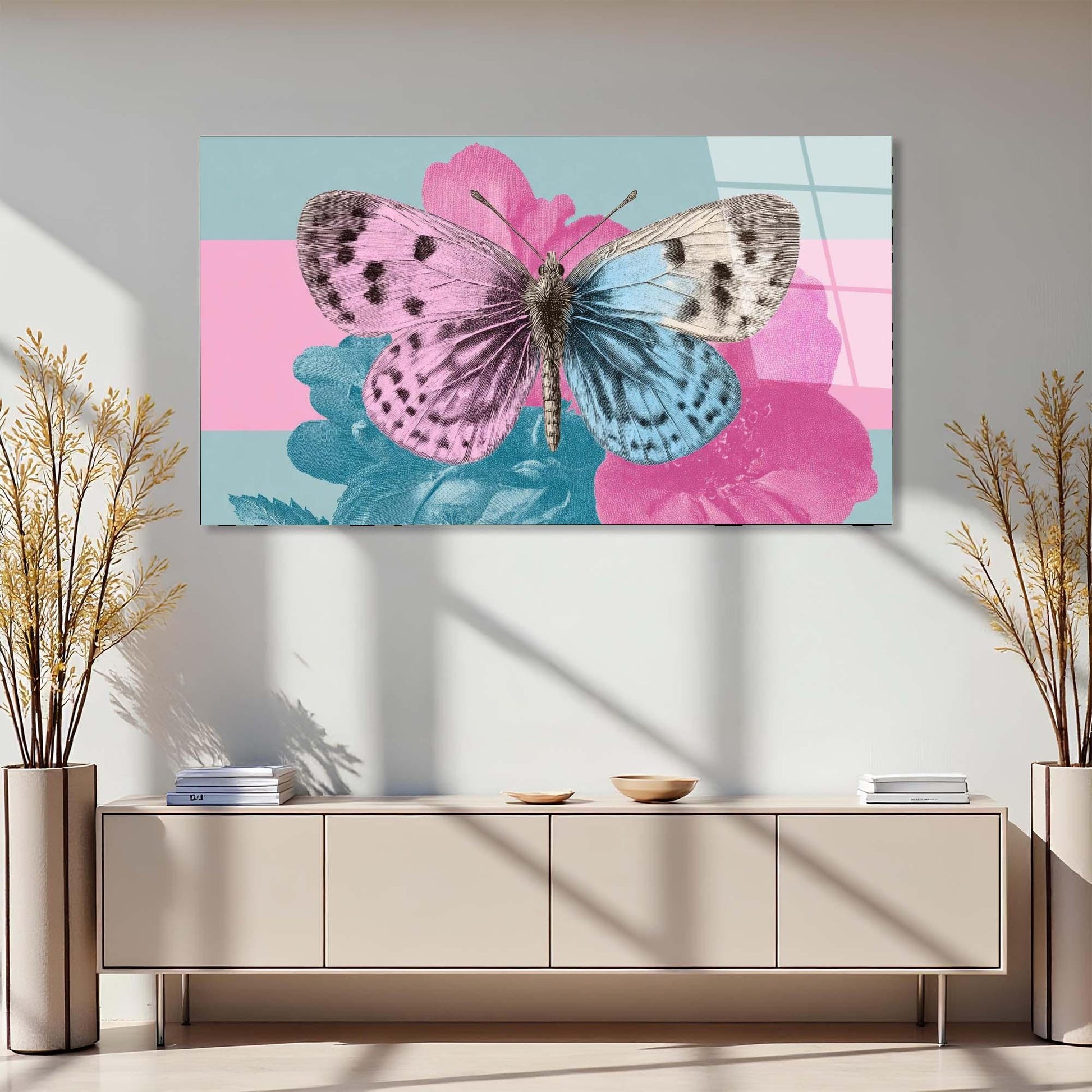 Butterfly on a pink flower painting above a beige console table with decorative plants.