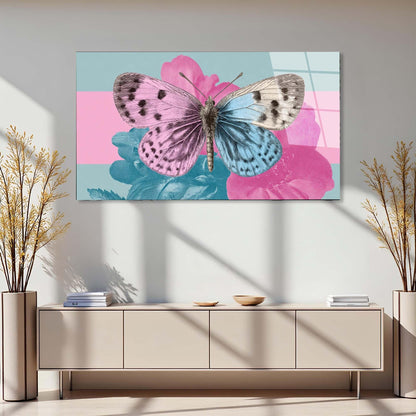 Butterfly on a pink flower painting above a beige console table with decorative plants.