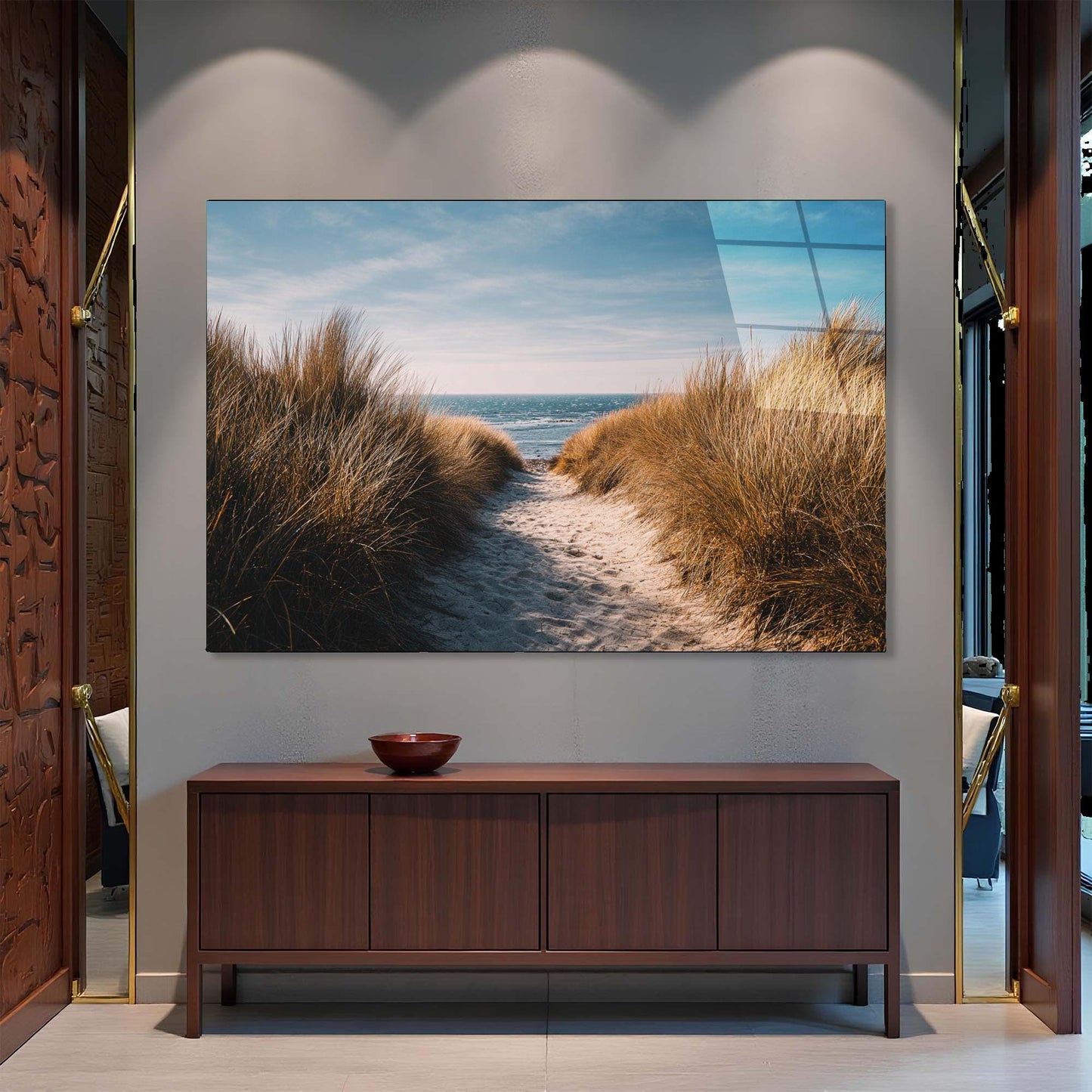 TV mounted on a wall displaying a beach scene, below which is a wooden cabinet.