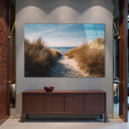 TV mounted on a wall displaying a beach scene, below which is a wooden cabinet.