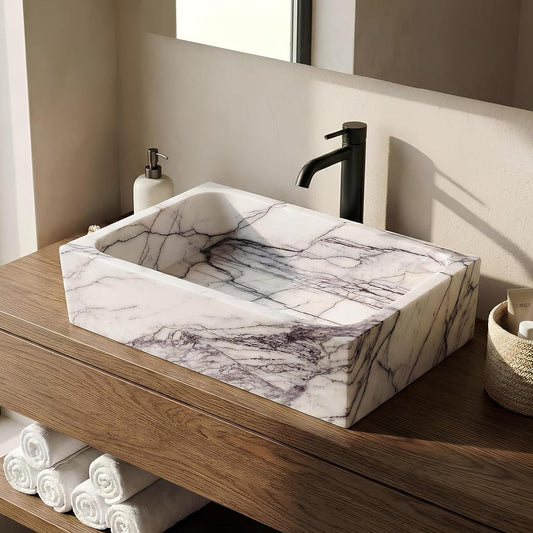 Bathroom vanity with marble countertop and wooden shelf.