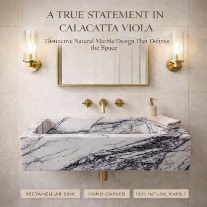 Bathroom with marble sink and gold fixtures, featuring text about Calacatta Viola marble.