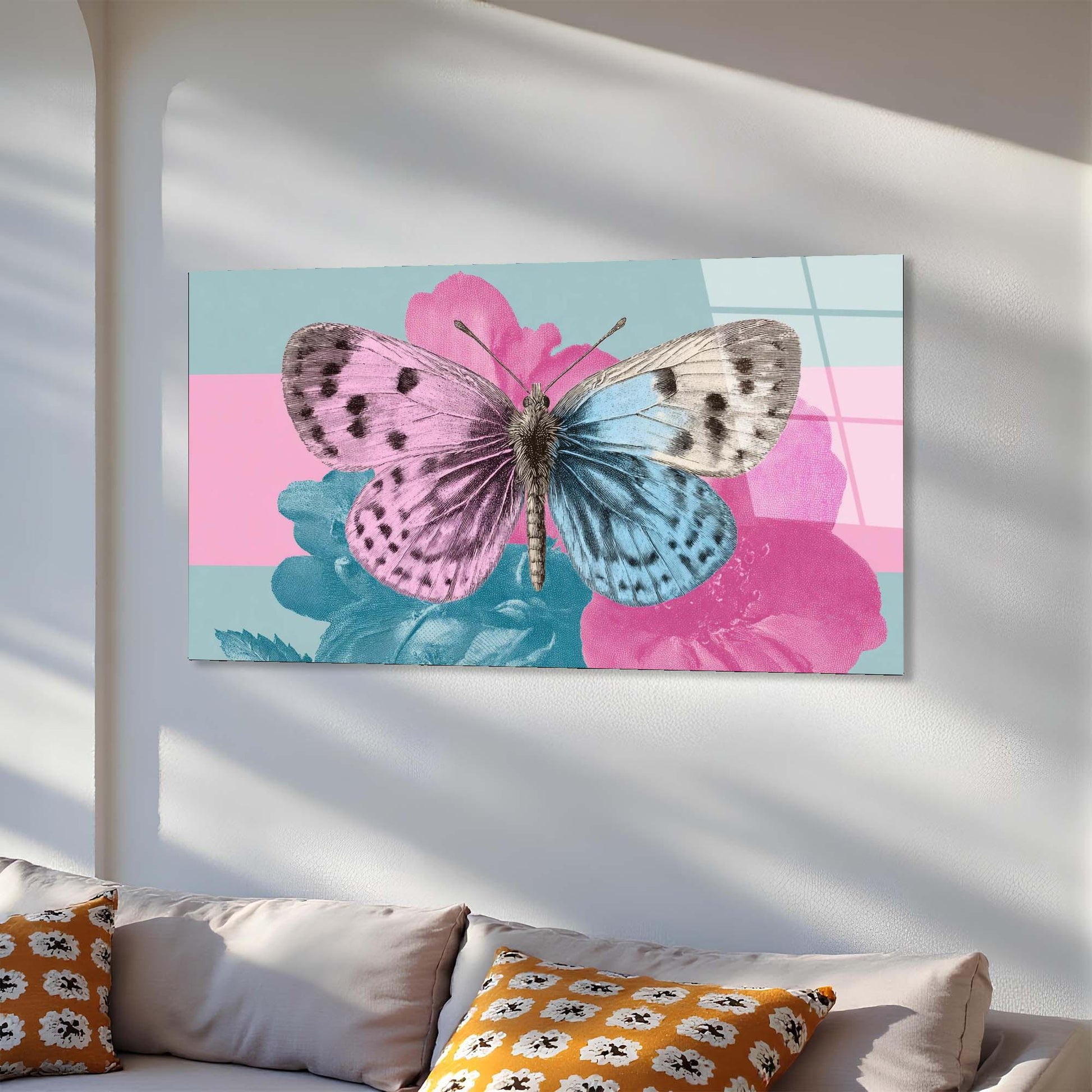 Canvas print of a butterfly on a floral background hanging on a wall above a sofa.