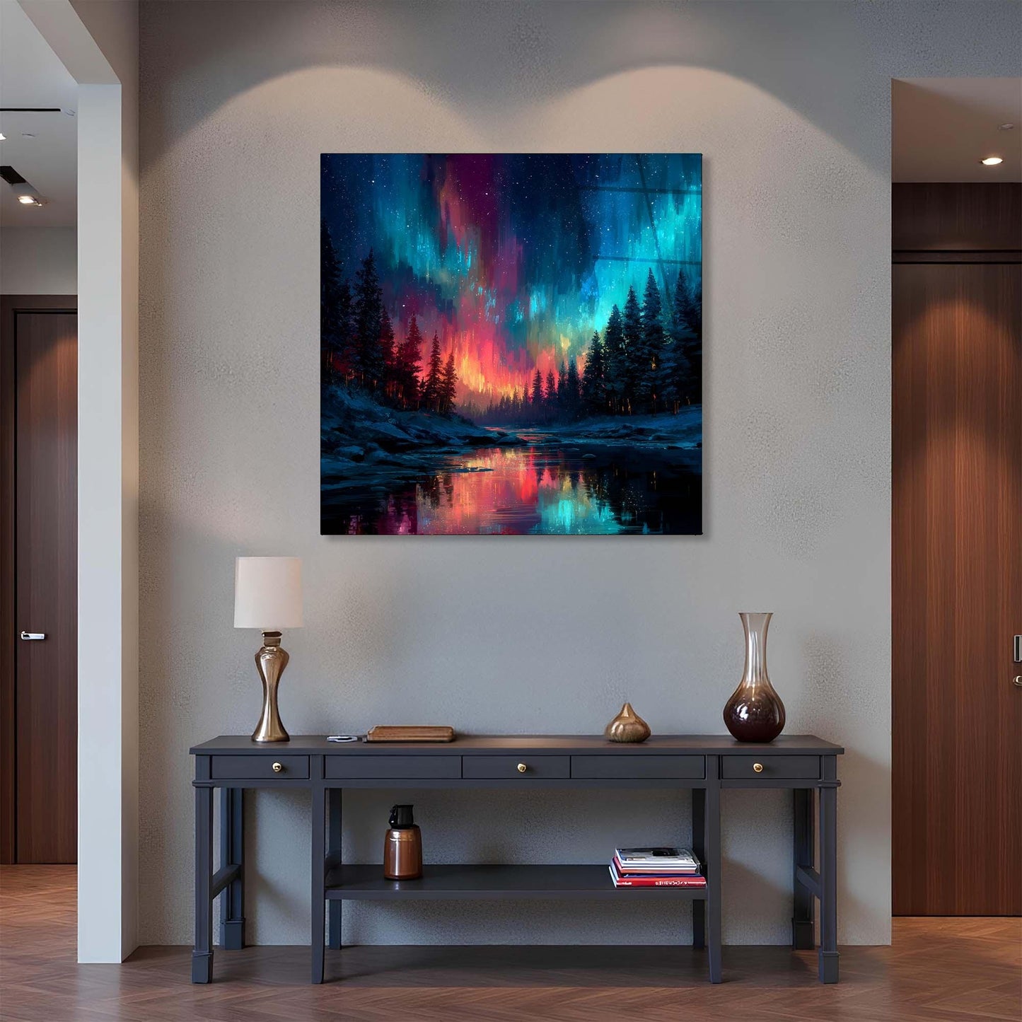 Framed artwork of a colorful landscape with trees and water on a wall above a dark wooden console table.