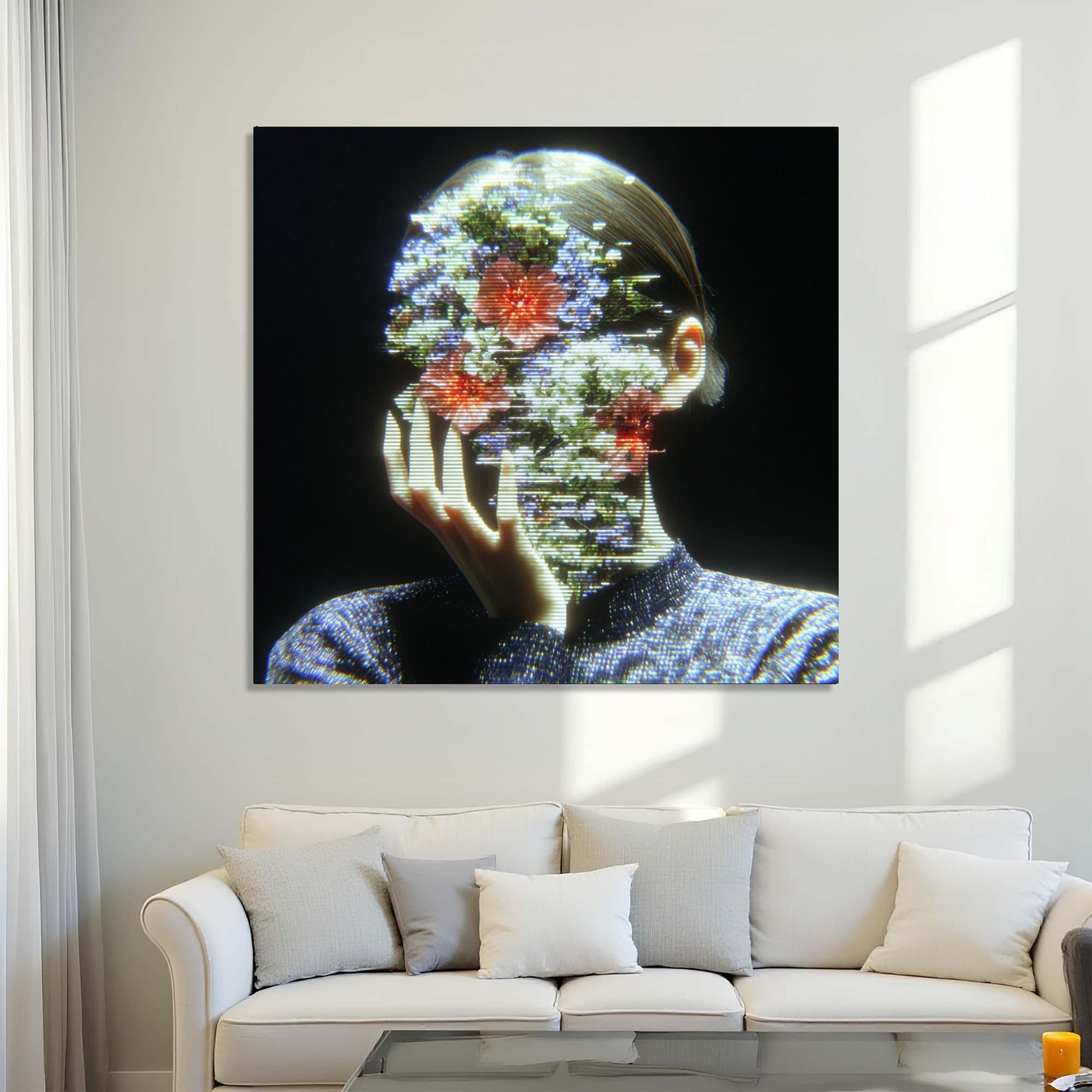 Abstract artwork of a person with floral and digital elements on a wall above a white sofa.