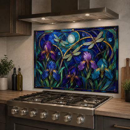 Purple iris and hummingbird glass kitchen backsplash protecting the wall behind a stainless steel sink.