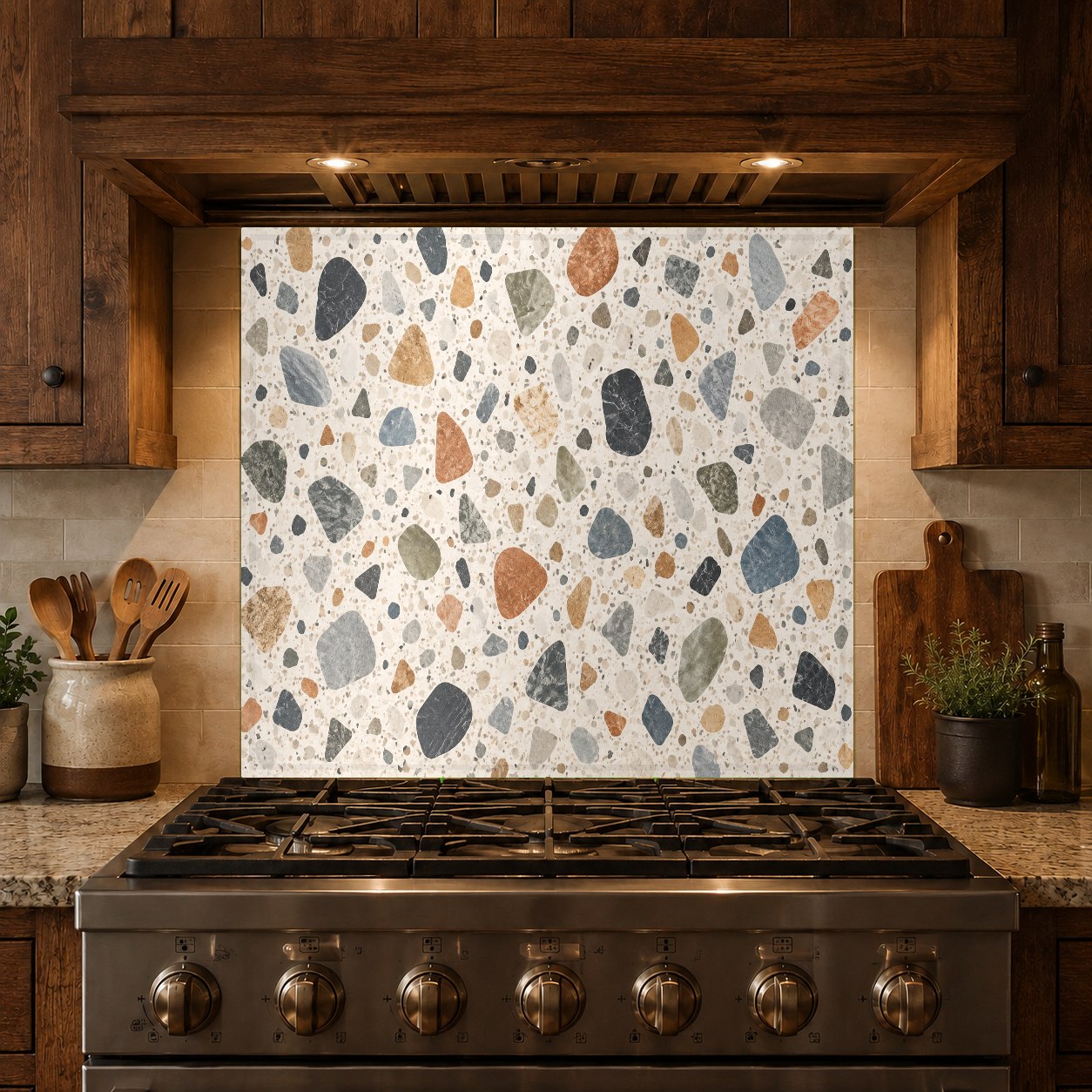 Stylish terrazzo stone look glass backsplash panel installed on a kitchen island prep station wall.
