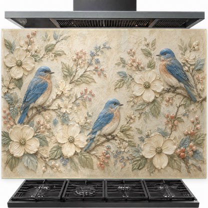 Blue bird tempered glass backsplash installed behind a modern stainless steel stove