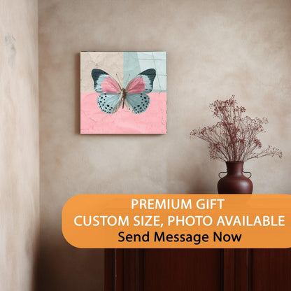 Canvas print of a butterfly on a pink and blue background hanging on a wall.