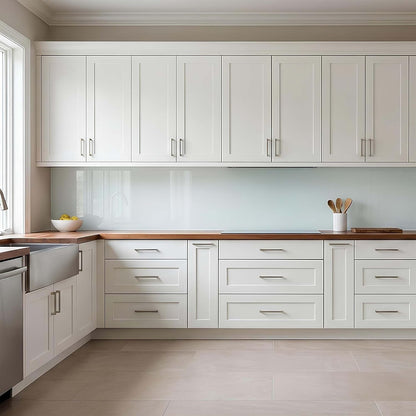 Modern kitchen with white cabinets, wooden countertops, and stainless steel appliances.