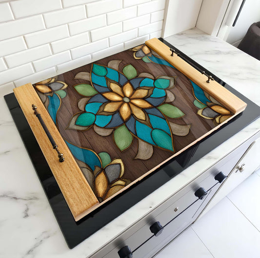 Decorative stove top cover with floral design on a stove