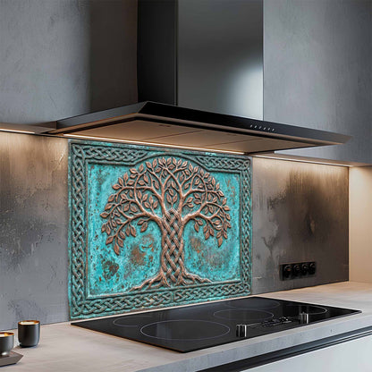Decorative glass backsplash with a tree design above a kitchen stove.