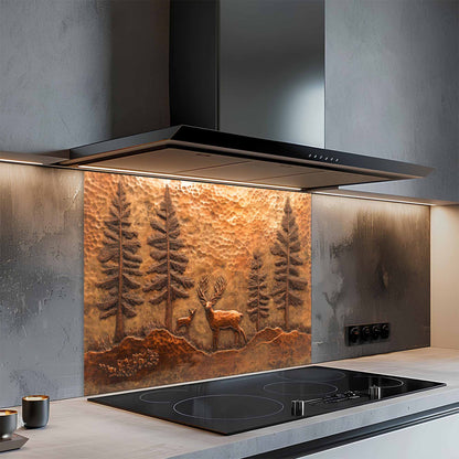 Modern kitchen with a decorative glass splashback featuring trees and deer.