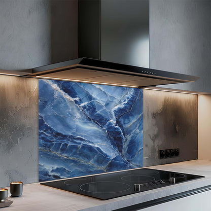 Modern kitchen with a blue marble glass backsplash and black cooktop.