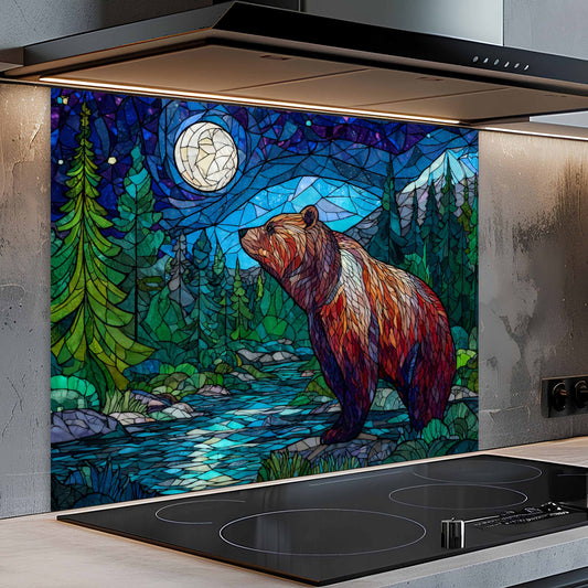 Stained glass-style backsplash of a bear in a forest scene above a stove.