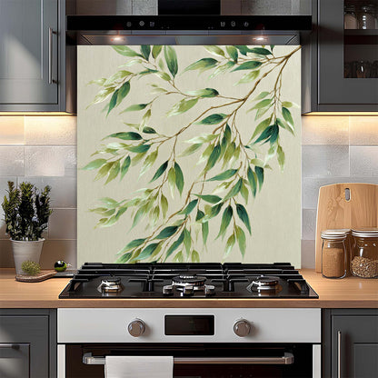 Kitchen stove with a decorative backsplash featuring green leaves and branches.