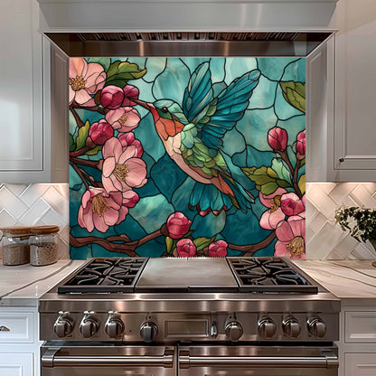 Stainless steel stove with a decorative backsplash featuring a stained glass-style design of a hummingbird and flowers.