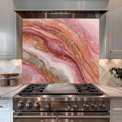 Stainless steel oven with pink and gold marbled look glass backsplash in a kitchen setting