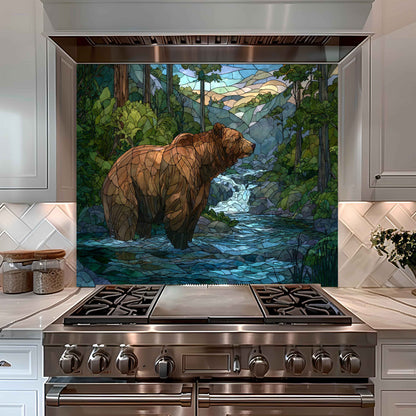 Stainless steel oven with a decorative glass panel featuring a bear in a forest design.