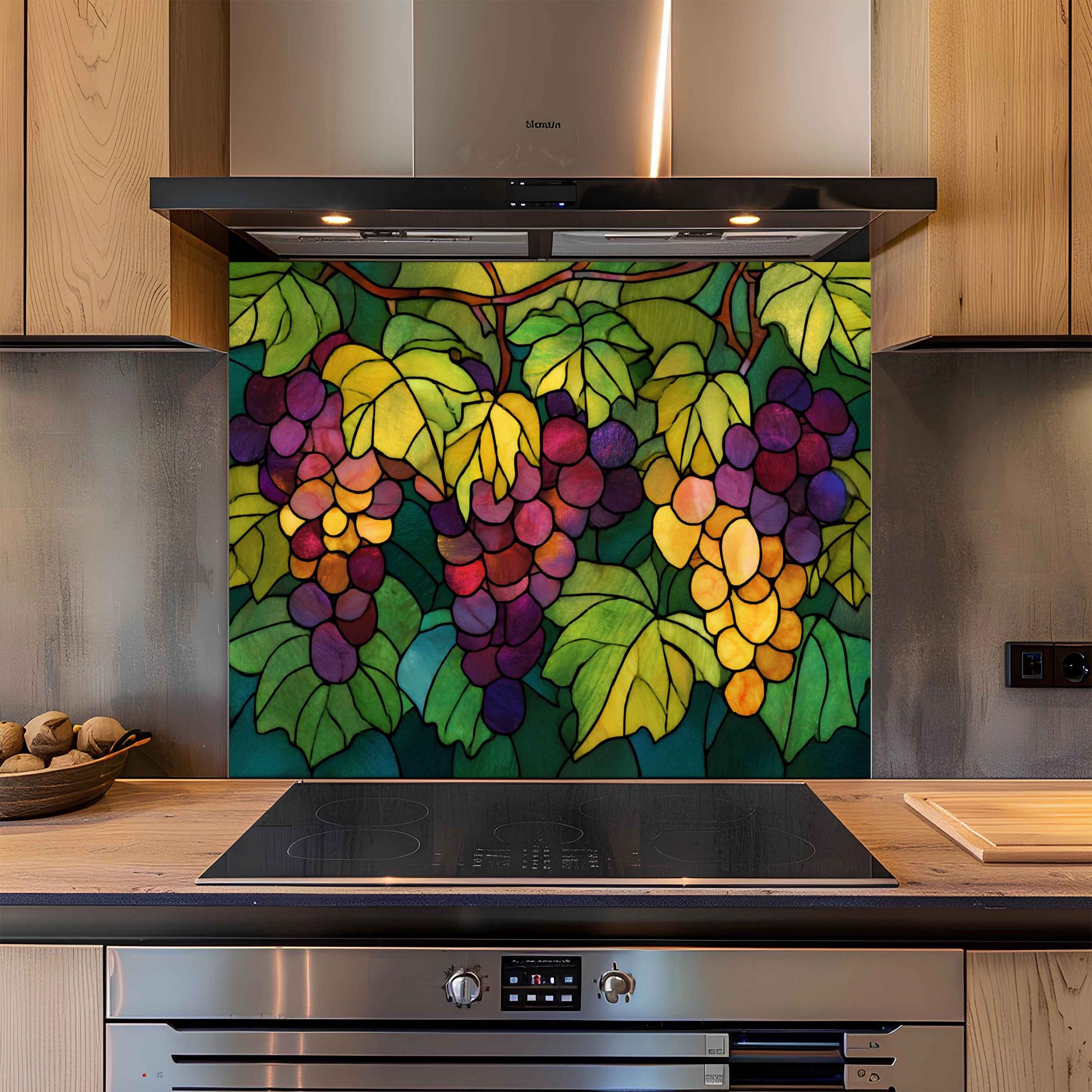 Kitchen with a colorful grapevine backsplash panel above a stove.
