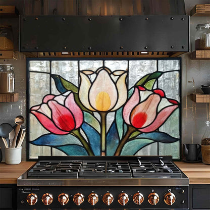 Stainless steel stove with a decorative glass backsplash featuring tulips in a kitchen setting.