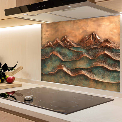 Kitchen with a decorative copper mountain backsplash above an induction cooktop.
