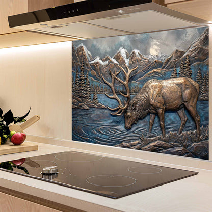 Decorative glass splashback with a deer design in a mountainous landscape above a kitchen stove.