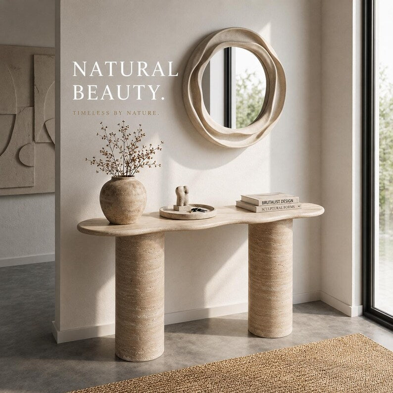 Beige console table with mirror and decor items against a light wall.