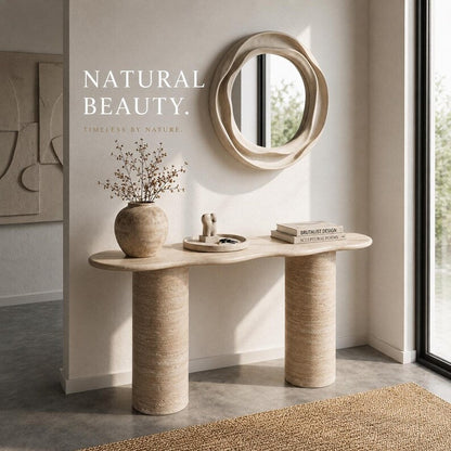 Beige console table with mirror and decor items against a light wall.