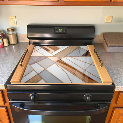Stainless steel stove with decorative glass panel in a kitchen stove top