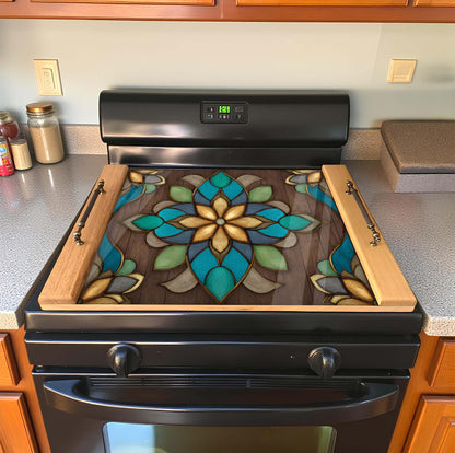 Stove with decorative glass cover featuring a floral design in a kitchen setting.
