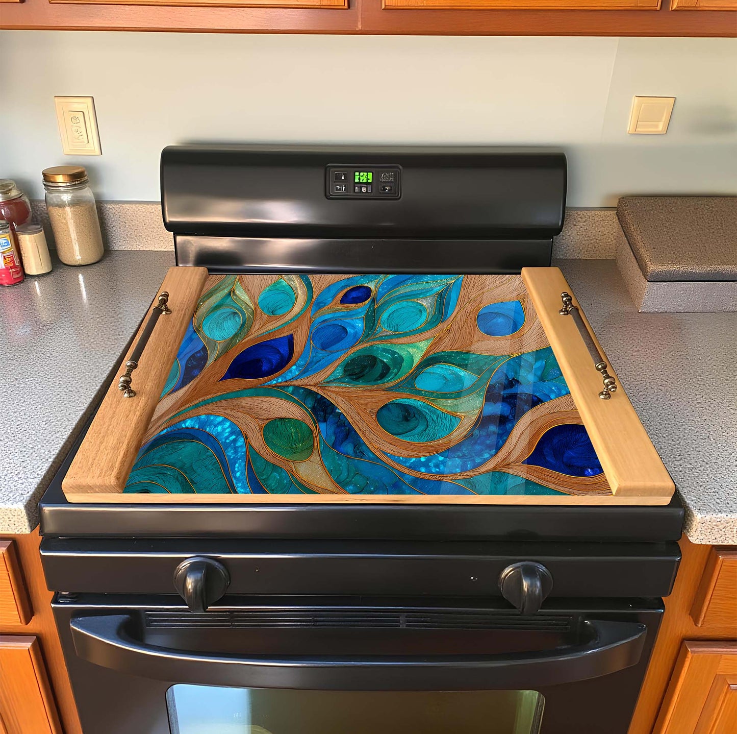 Stove with decorative glass top featuring blue and green peacock feather design.