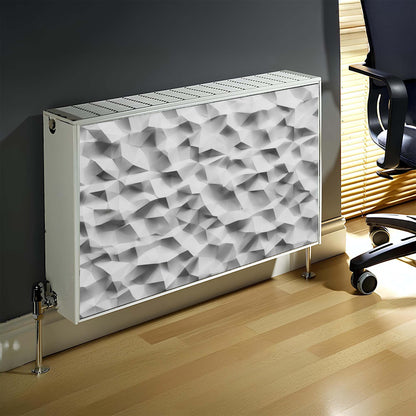 Decorative magnetic radiator cover with geometric pattern on a wall next to a chair.