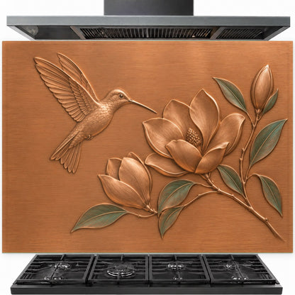 Magnolia Hummingbird tempered glass backsplash installed behind a stainless steel kitchen stove