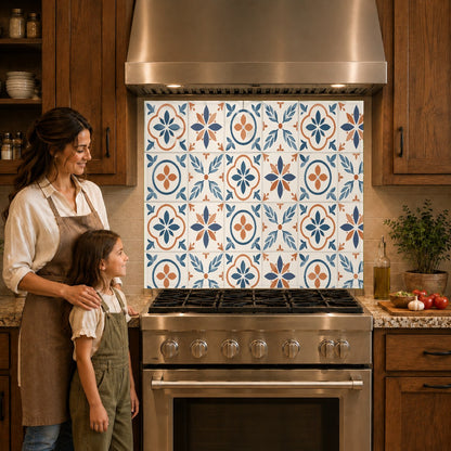 Vibrant blue and terracotta tile pattern glass kitchen backsplash behind a gas cooktop