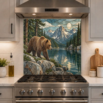 High-gloss kitchen glass backsplash with a grizzly bear and pine trees behind a sleek stainless steel range.