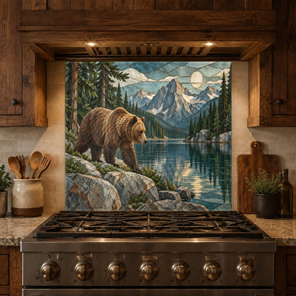 Rustic grizzly bear stove guard panel complementing a mountain-style kitchen island with granite countertops.